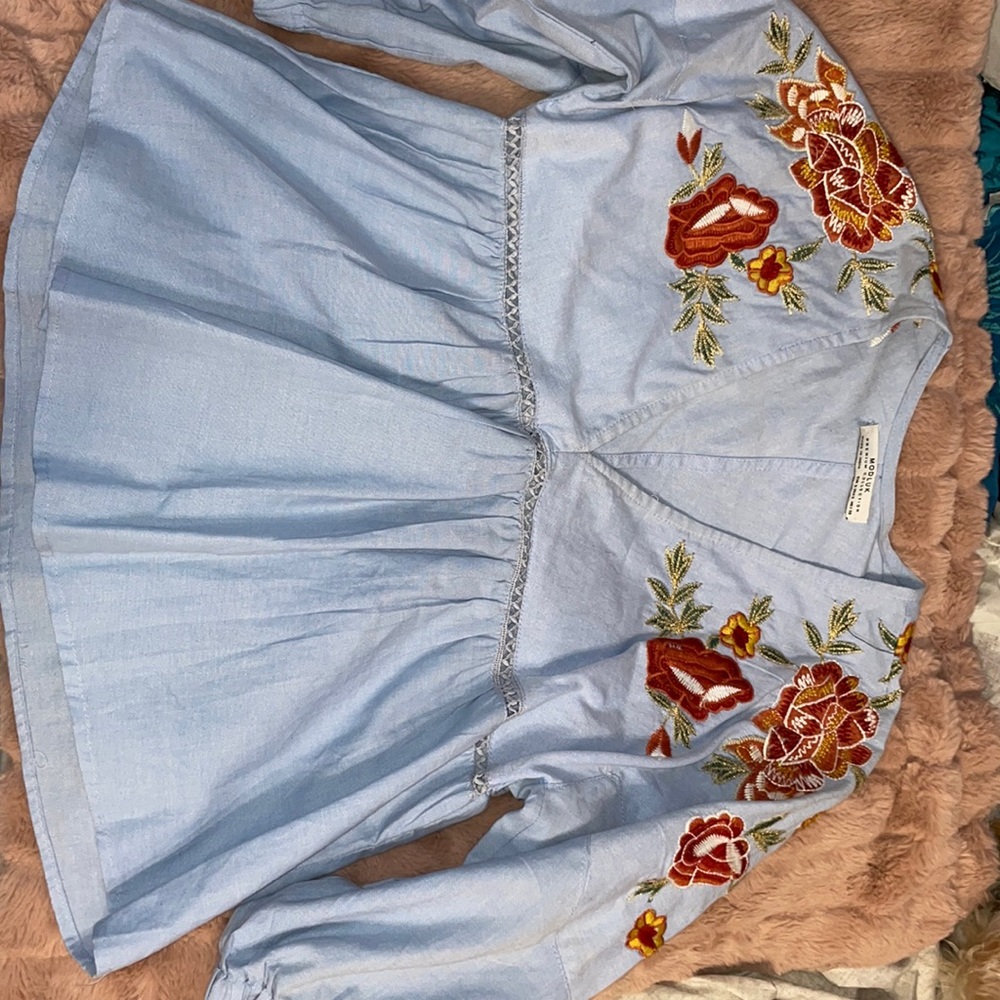 Sky blue top (small size) with embroidered neck.